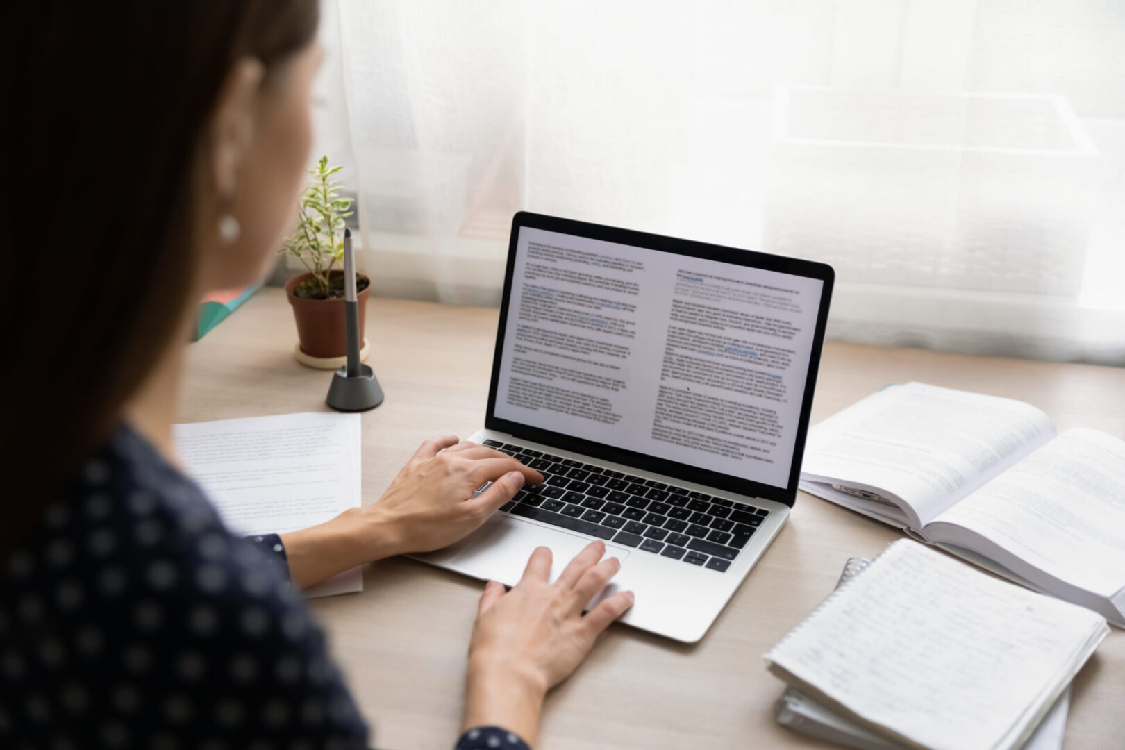 A person sitting at a table with a laptop.