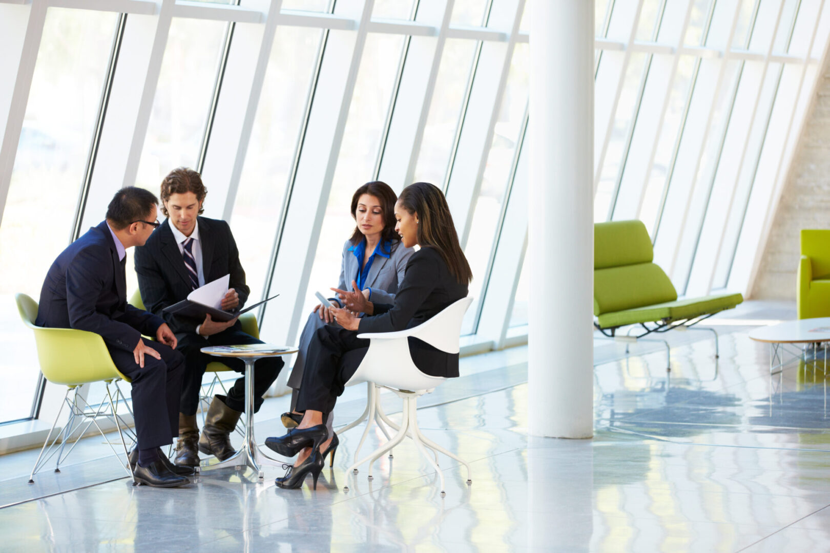 A group of people sitting around in an office.